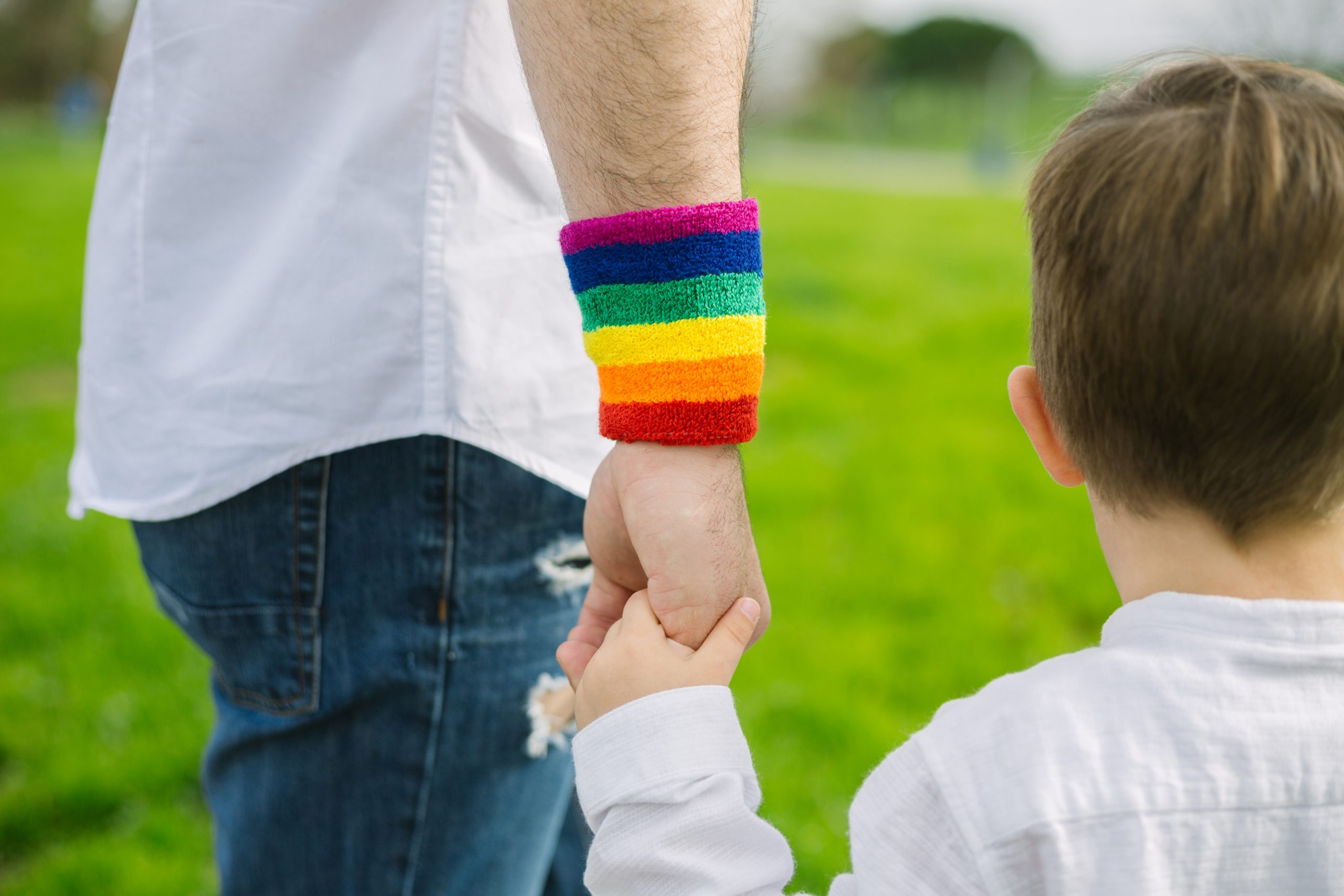 AdobeStock_©_XavierLorenzo_Gay-father-holding-his-son's-hand-in-a-park